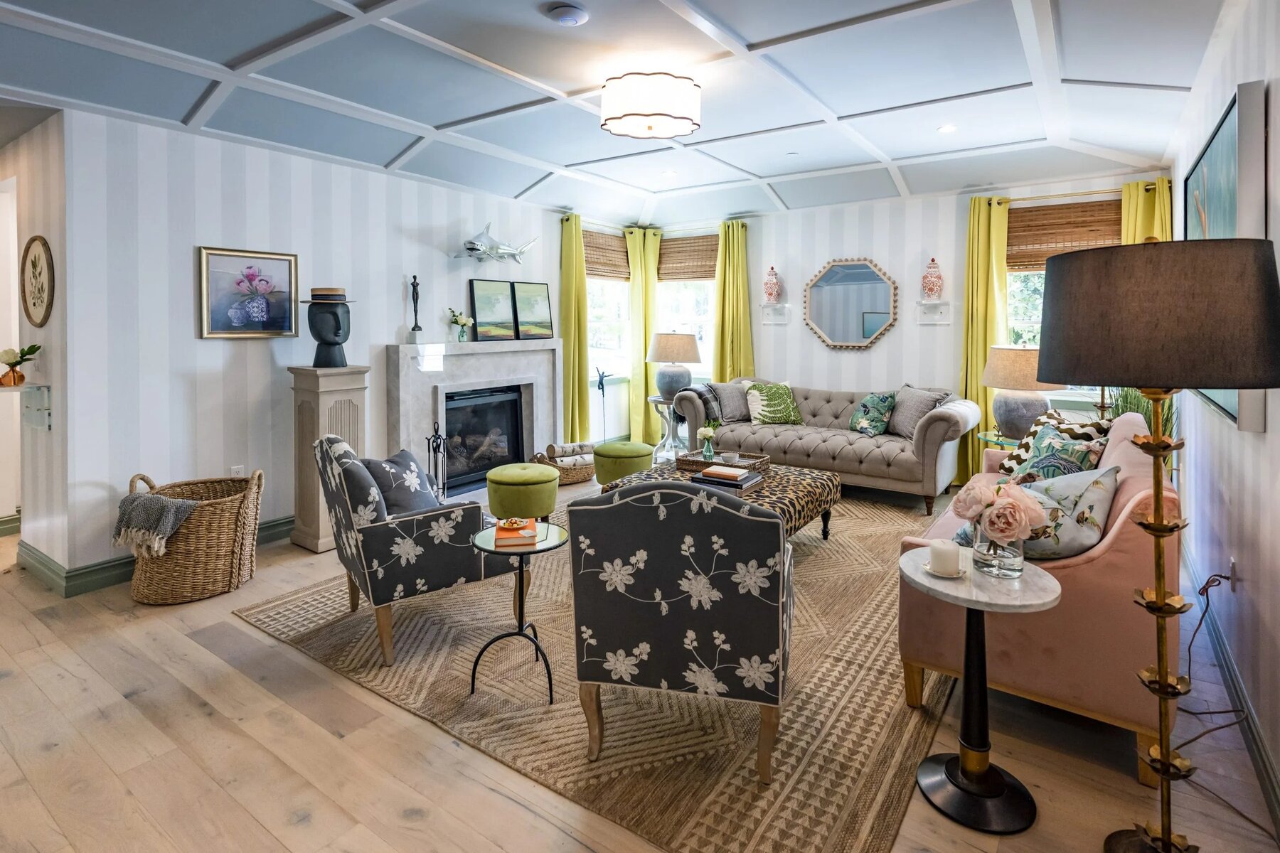 Colorful living room with floral armchairs, tufted sofas, bold decor, and a coffered ceiling