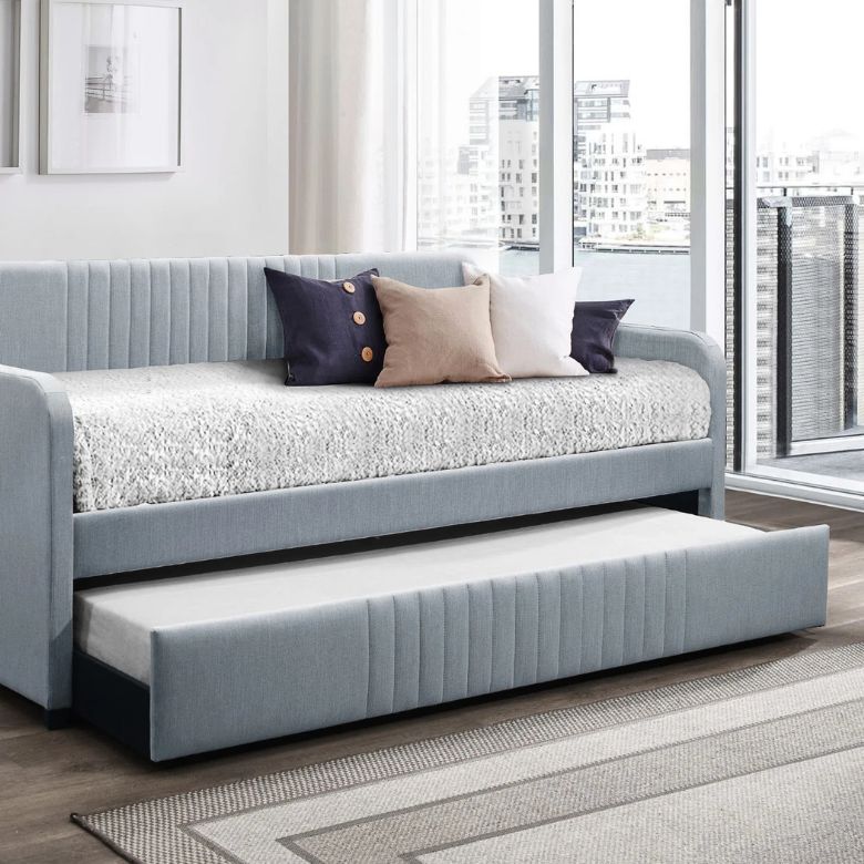 A daybed with a mattress and a trundle.