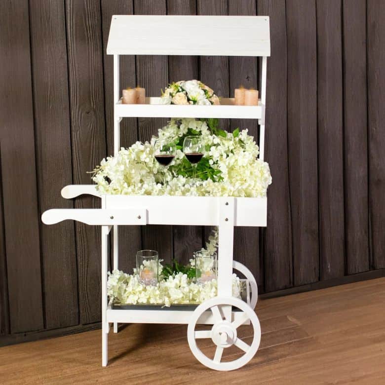 white covered wooden flower cart