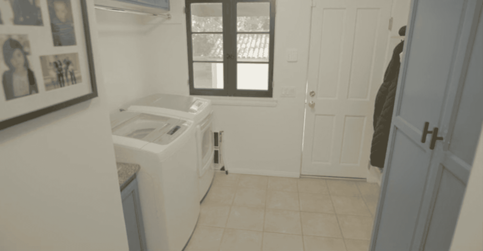 Laundry room with washer, dryer, and blue cabinets