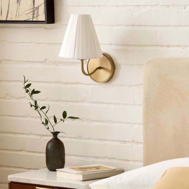 bronze wall sconce with white pleated shade