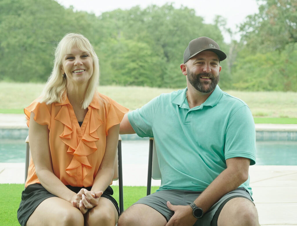 chasing the west premiere couple sarah and thomas smiling in front of their pool on their new property in Val Alstyn, Texas