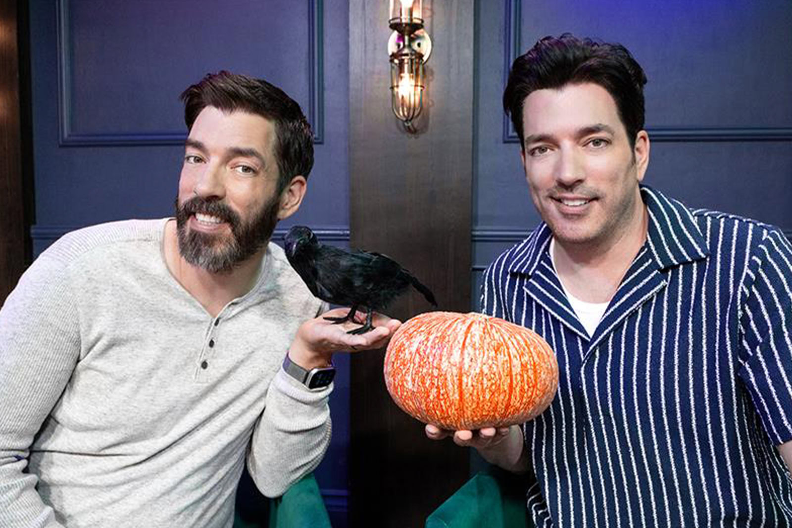 drew scott and jonathan scott posing with a pumpkin for halloween house stumpers youtube video