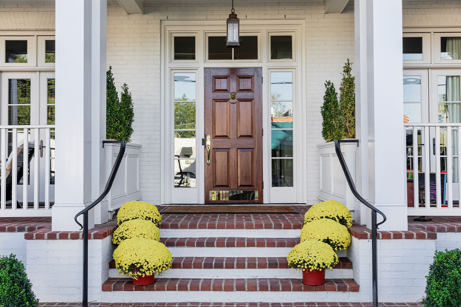 flowers lining a staircase up to a house