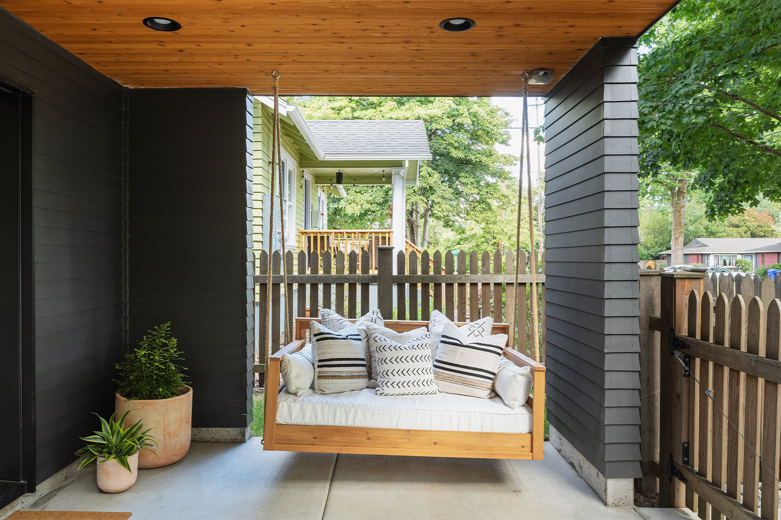 modern porch with swing and black paint