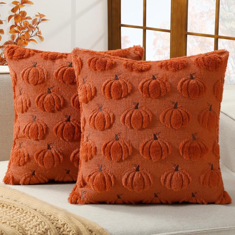 orange throw pillows with embroidered pumpkins