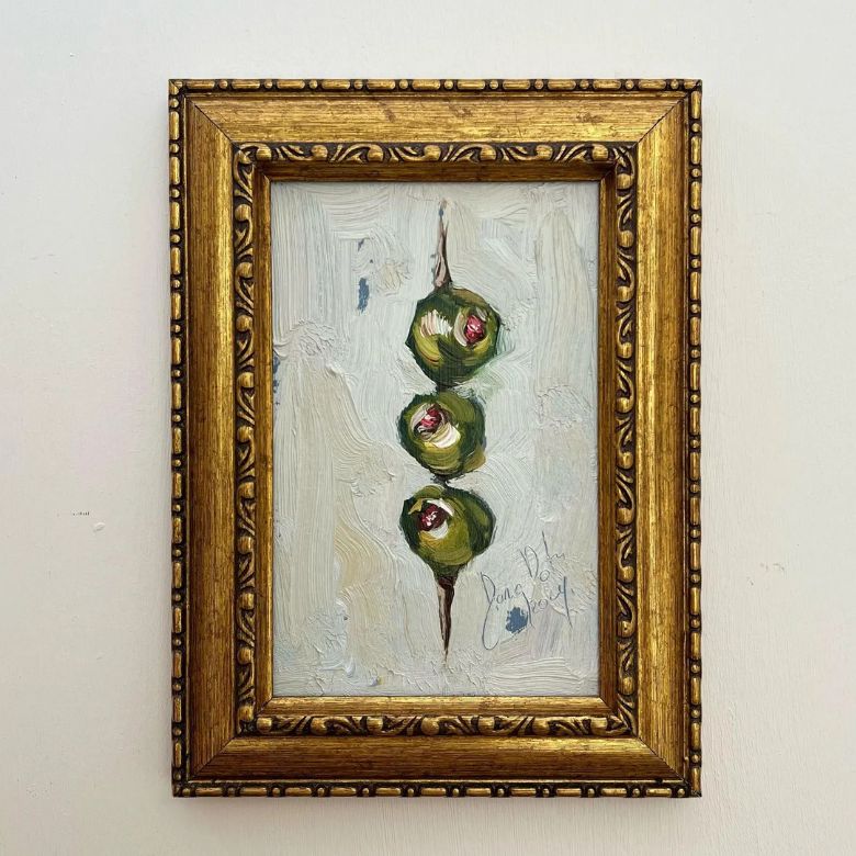 framed oil painting of olive stack on skewer