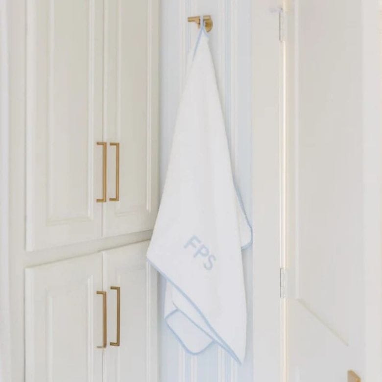 white bath towel with blue trim