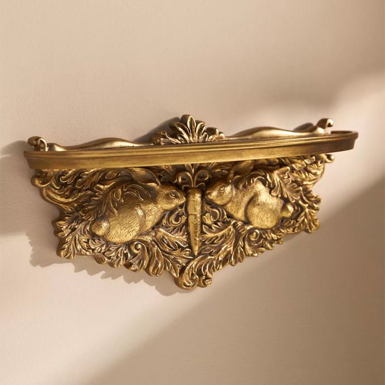 brass shelf with rabbits