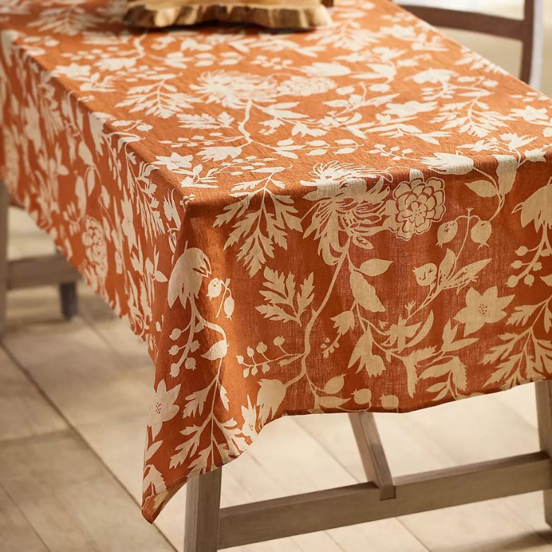 orange tablecloth with white autumnal botanicals