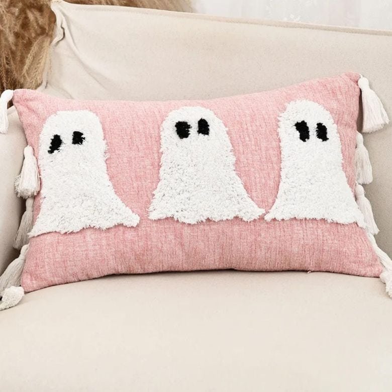 pink throw pillow with white ghosts