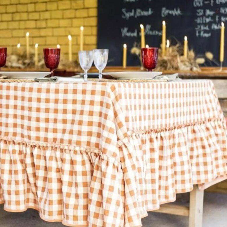 orange and white gingham tablecloth with ruffle bottom