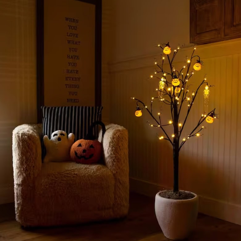cute and cozy interior with halloween twig tree