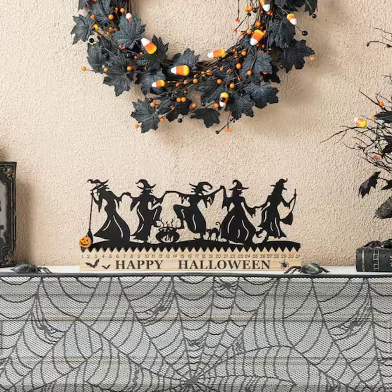 cute halloween mantel decor with witch silhouette and "happy halloween" letters