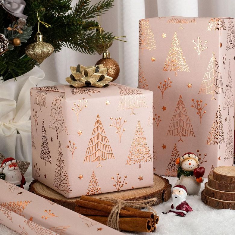 pink wrapping paper with gold christmas trees