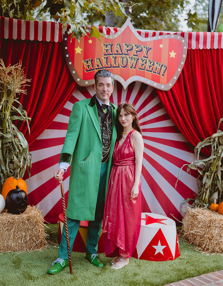 jonathan scott and zooey deschanel posing at their 2025 haunted circus halloween party