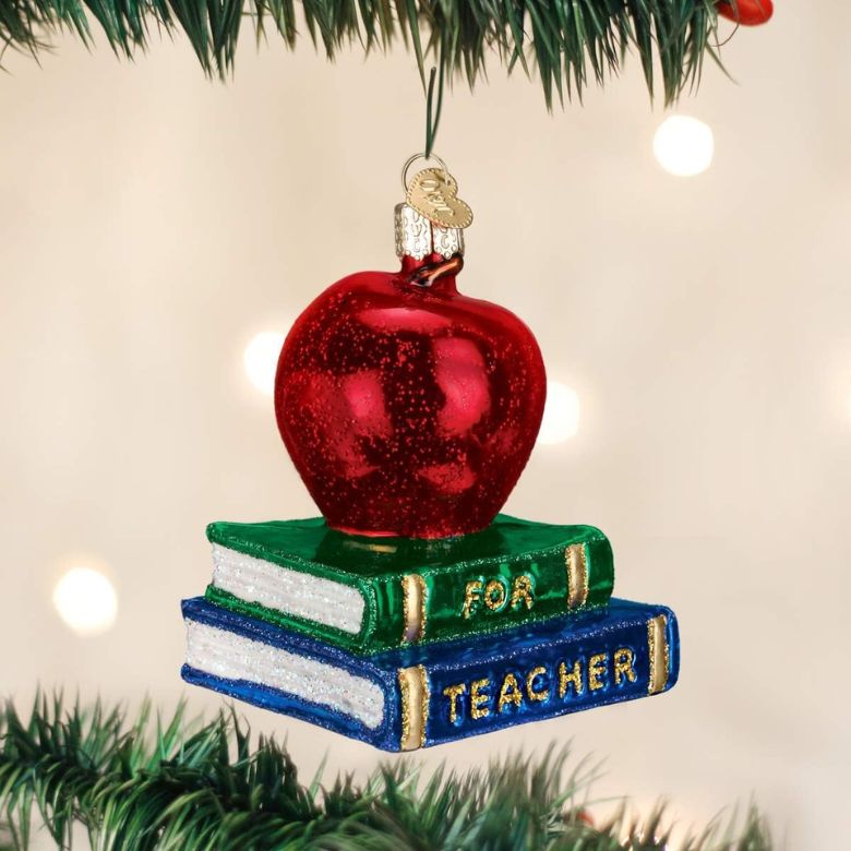 teacher ornament with apple on top of book stack