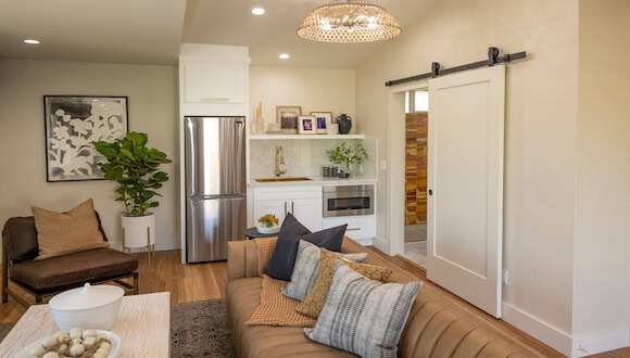 View of living area and kitchen with a peak into the bathroom