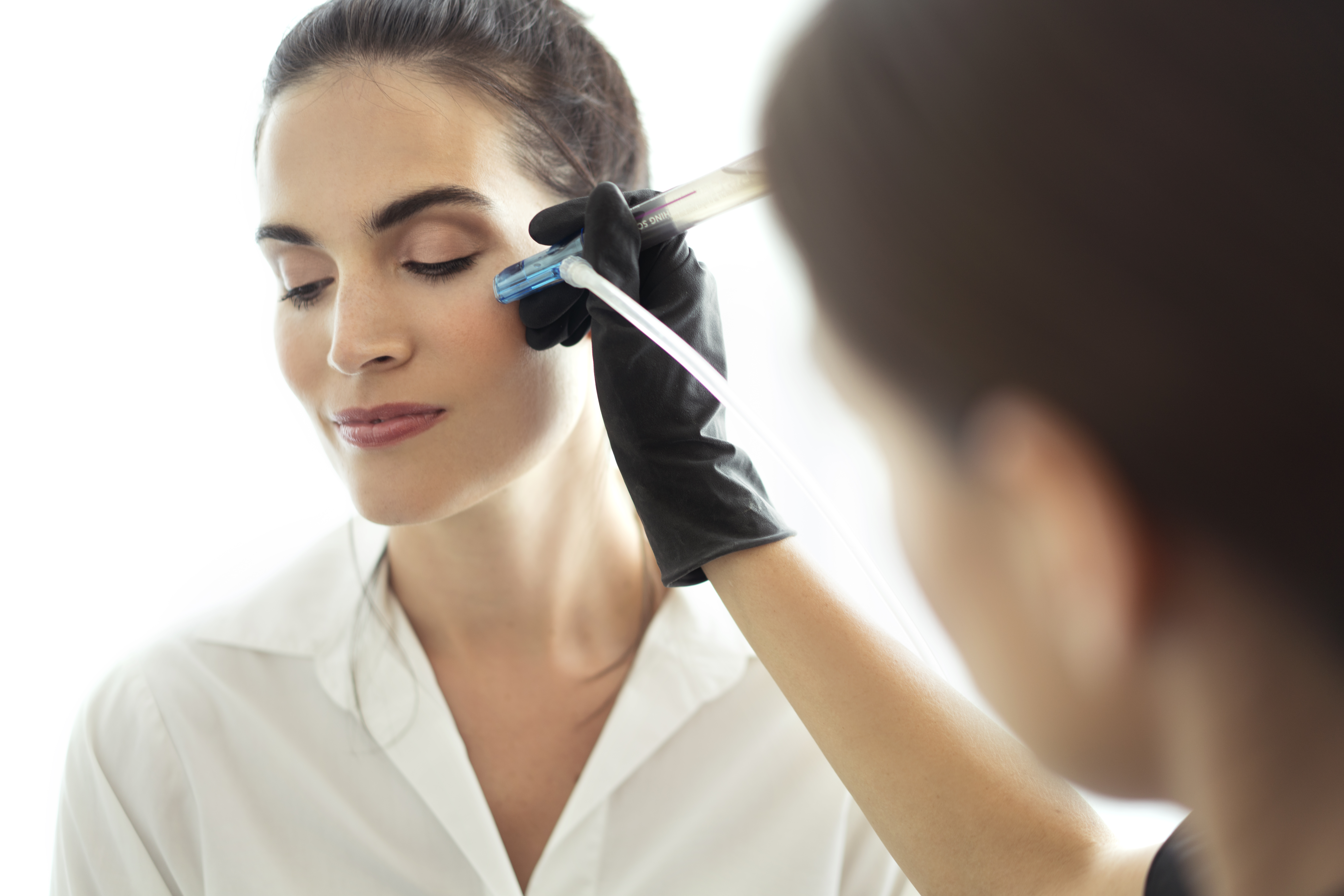 Esthetician giving PERK Eye Treatment