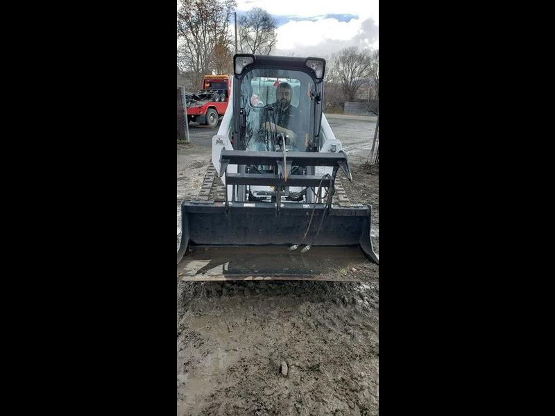 Excavator machine used for construction and site preparation at equipment rental event.