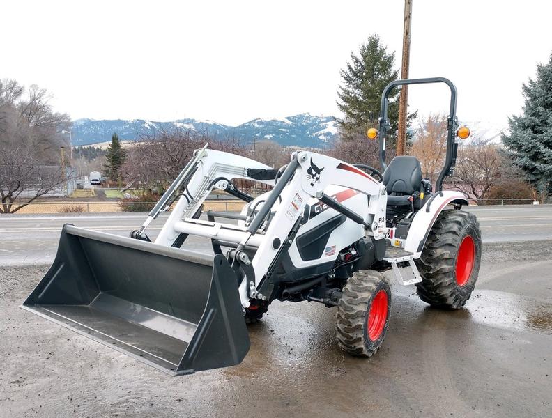 Compact loader with front bucket for construction and landscaping projects.