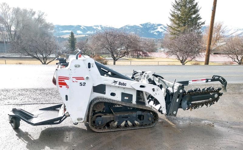 Skid steer loader with tracks, ideal for construction and landscaping projects.