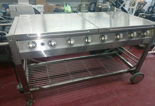 Heavy-duty stainless steel commercial gas grill for rental use.