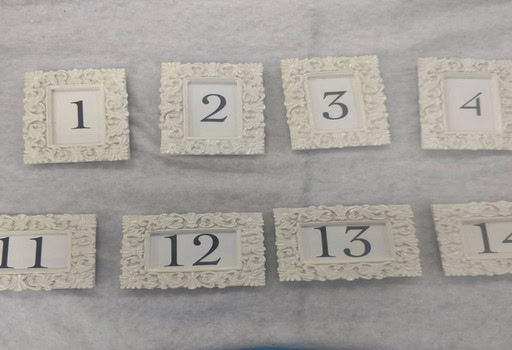 Elegant ornate frames with numbers for party and equipment rentals.