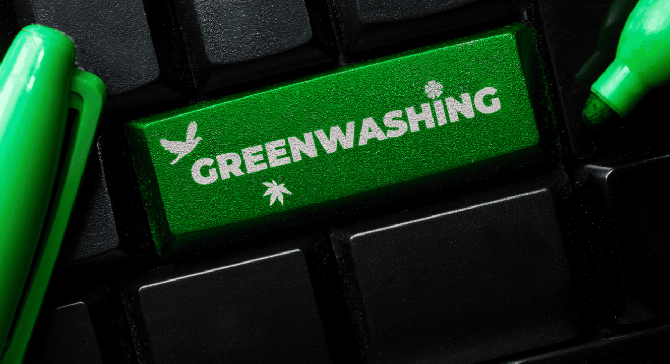 Eco-friendly green computer keyboard key with "Greenwashing" text and environmental symbols.