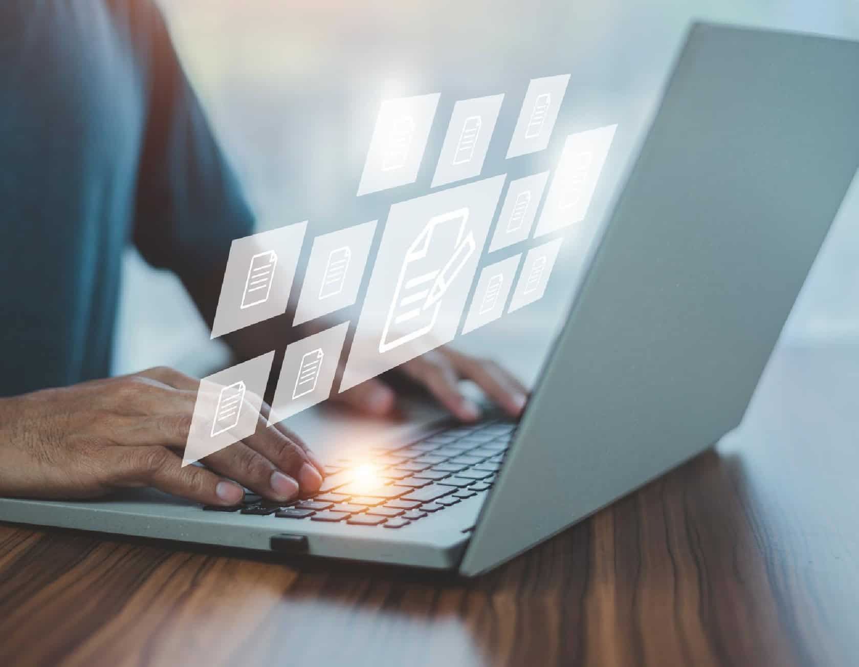 Digital file management and cloud storage concepts, with a person using a laptop to organise files and data.