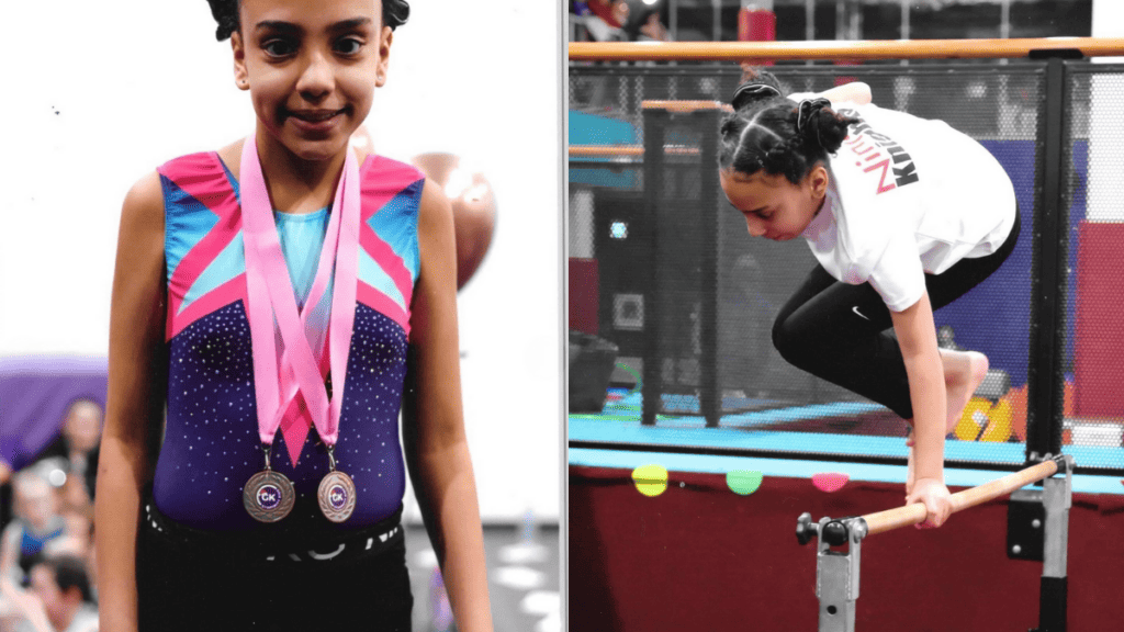 Medalist girl in gymnastics uniform with medals and pink ribbons, young athlete smiling after competition, celebrating her achievements.