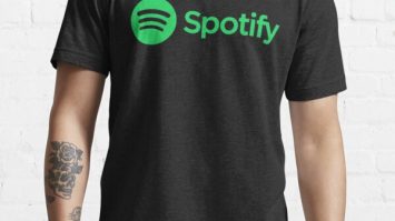 Spotify logo t-shirt, black choice for digital music fans, trendy casual wear, music streaming branding, modern music merchandise, Hypebot editorial image, music industry apparel, promotional music fashion, streetwear for music lovers, casual music brand clothing, lifestyle apparel for music streaming enthusiasts.