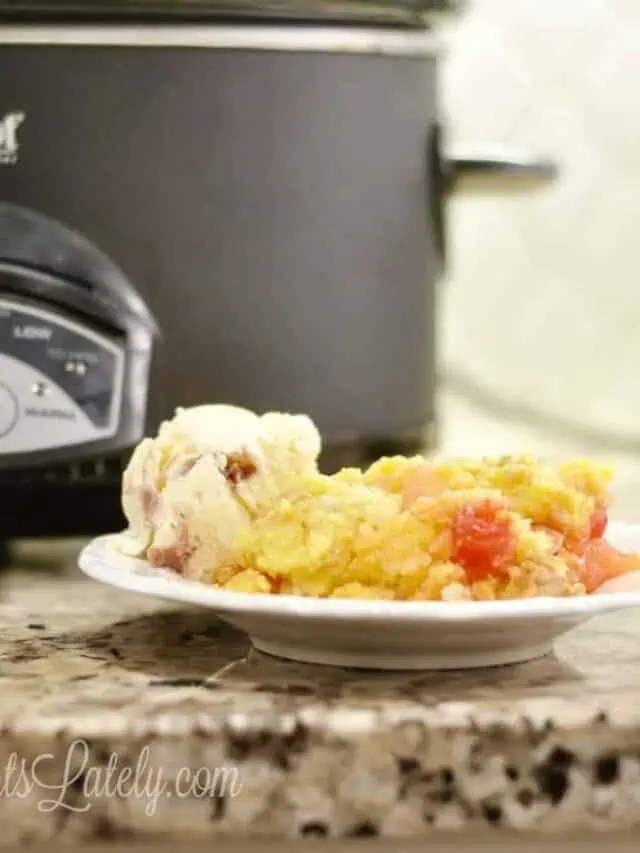 dump cake on a plate in front of a crock pot