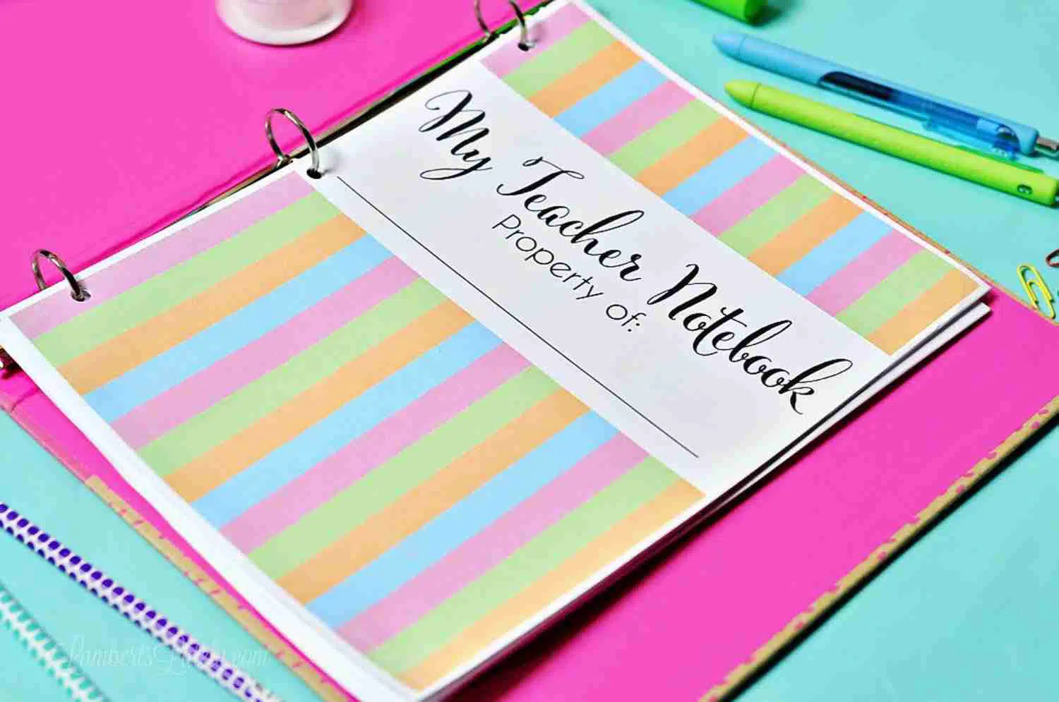 teacher planner in a pink notebook.