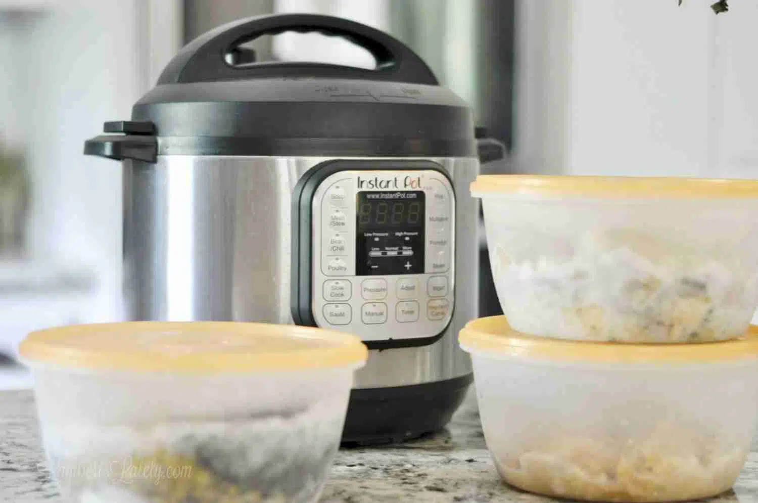 instant pot next to freezer meals stacked on a counter.