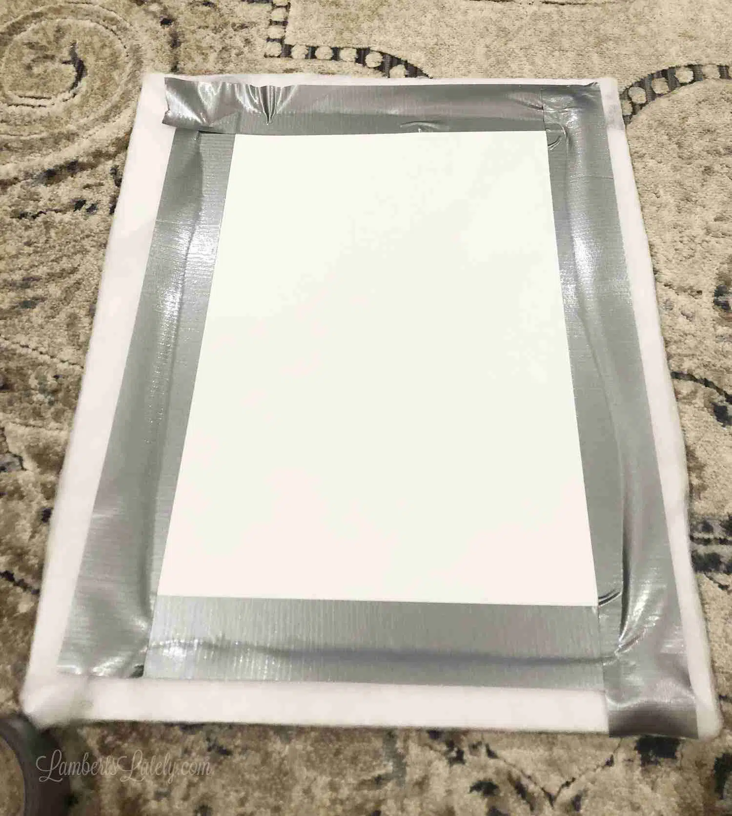 fabric duct taped onto a frame.