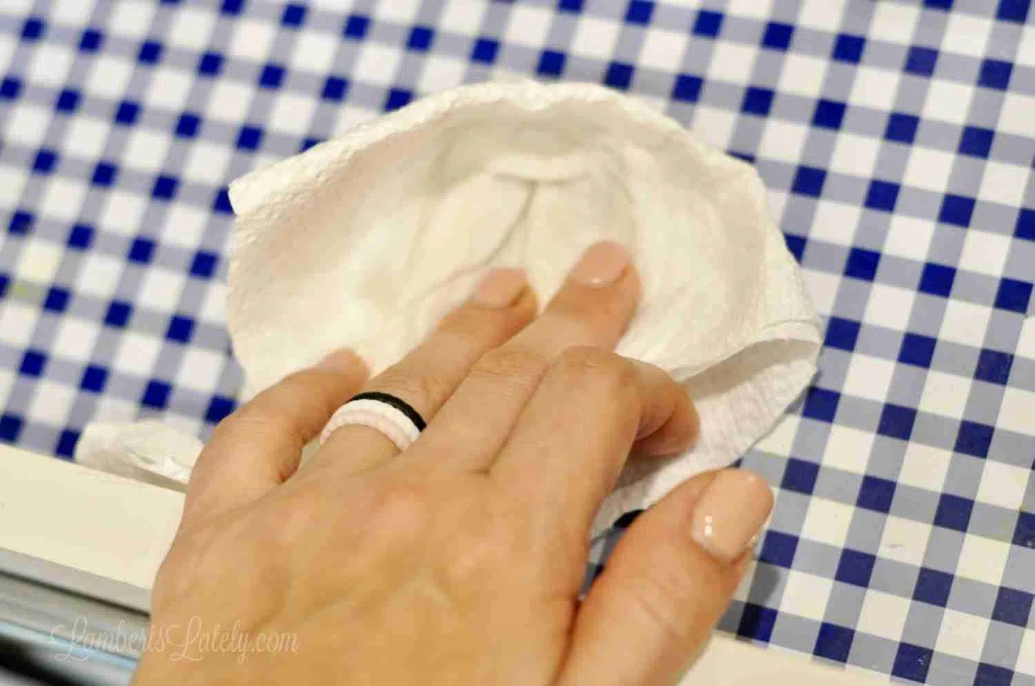 wiping blue gingham contact paper.