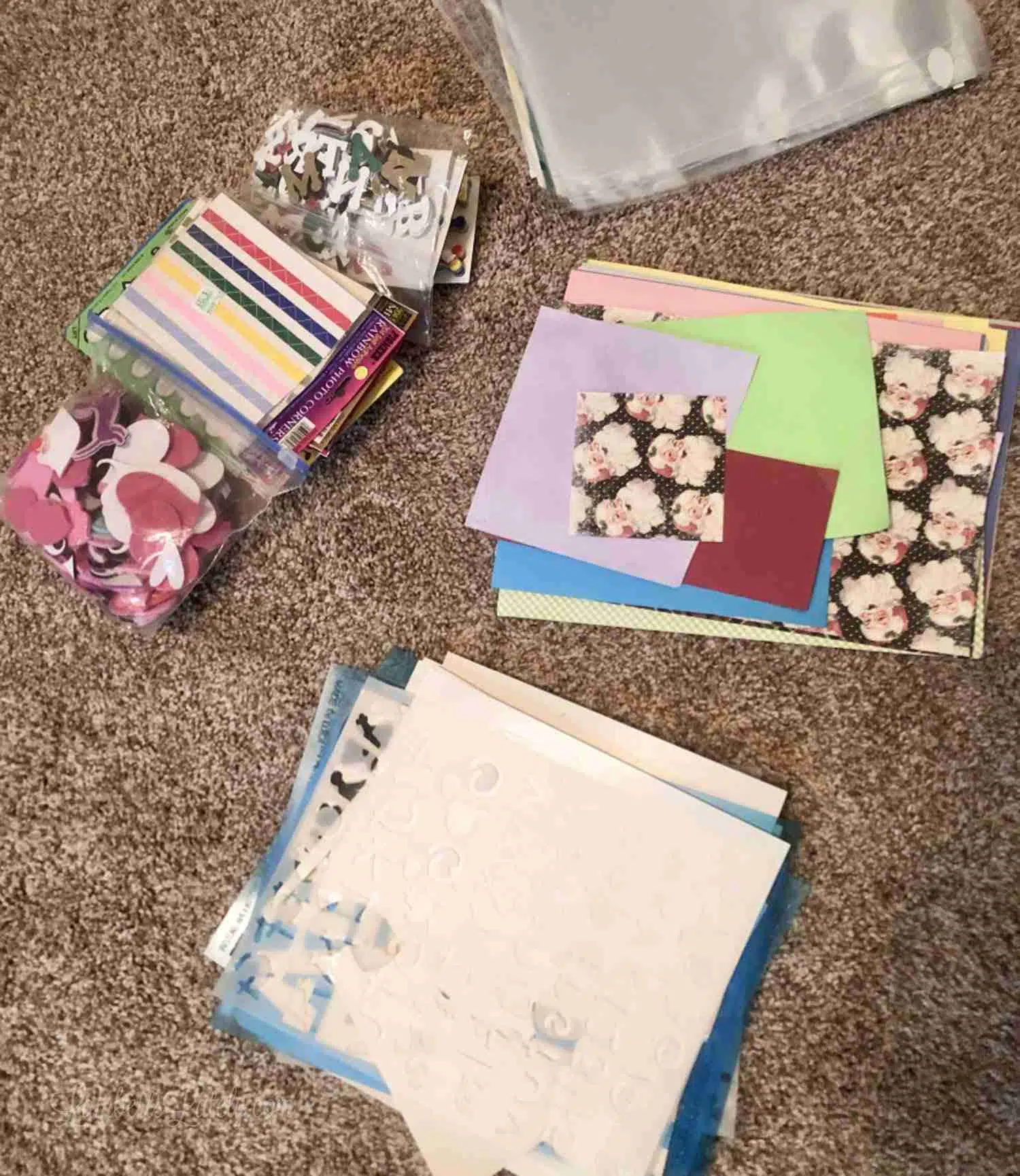 craft supplies being sorted on the floor of a craft room.