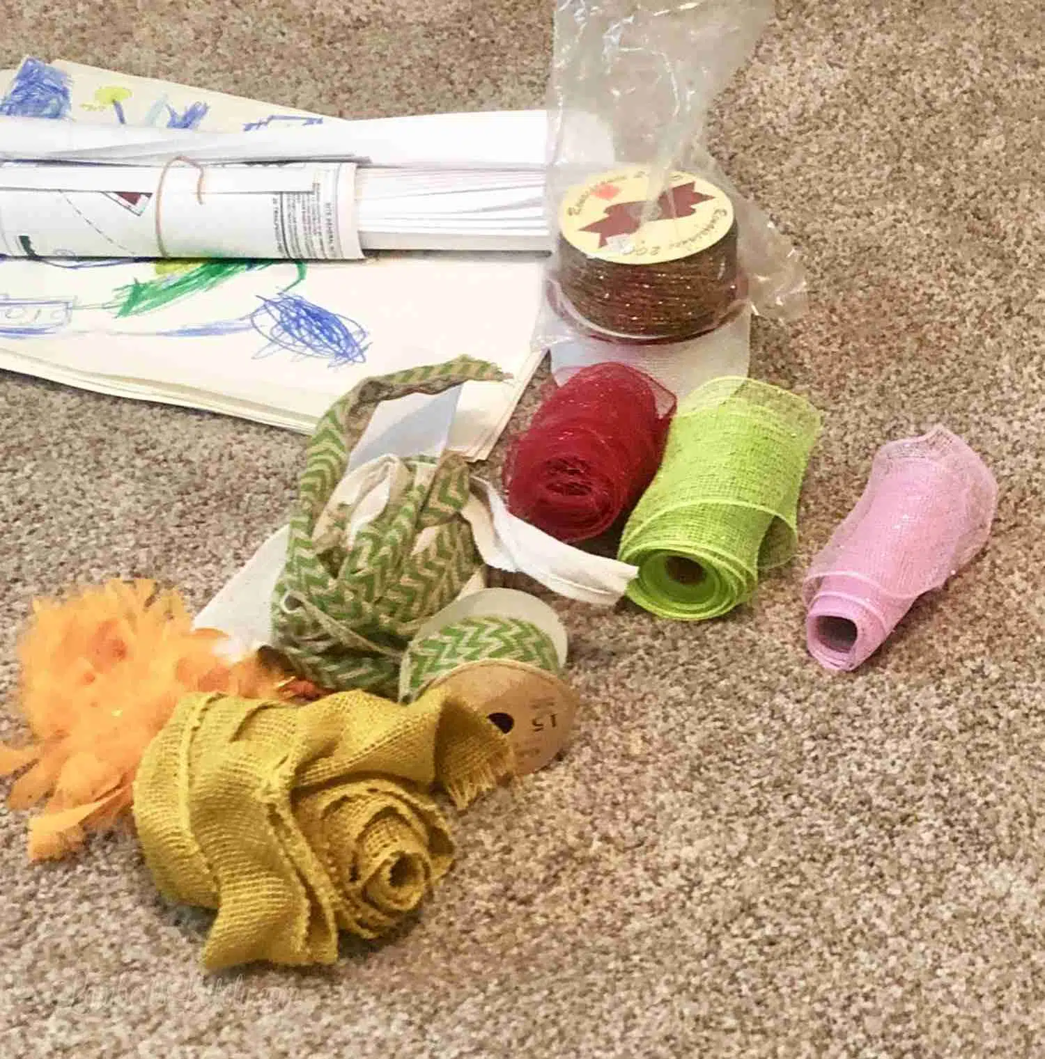 stack of ribbons on a carpeted floor.
