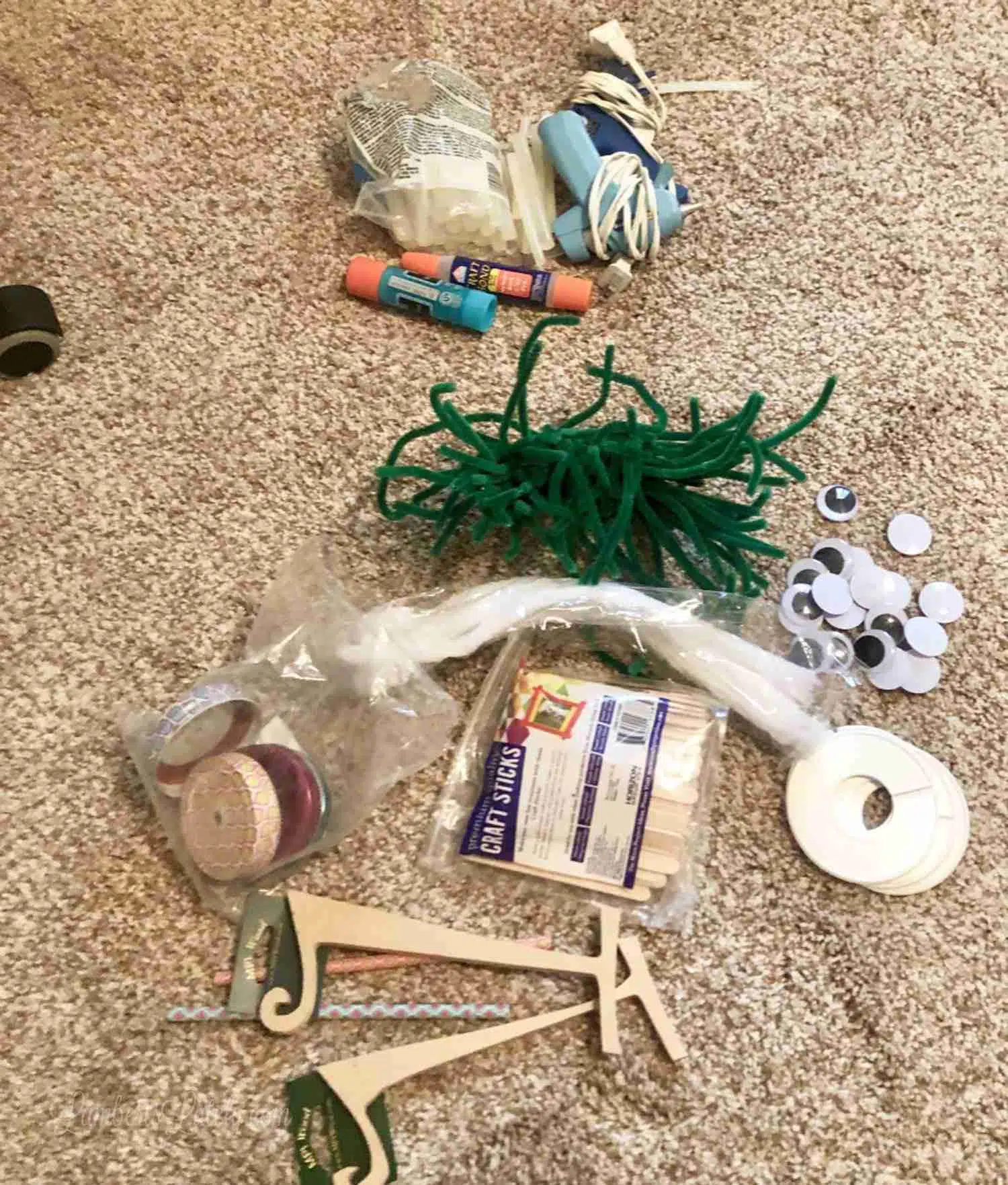 craft supplies on a carpeted floor.