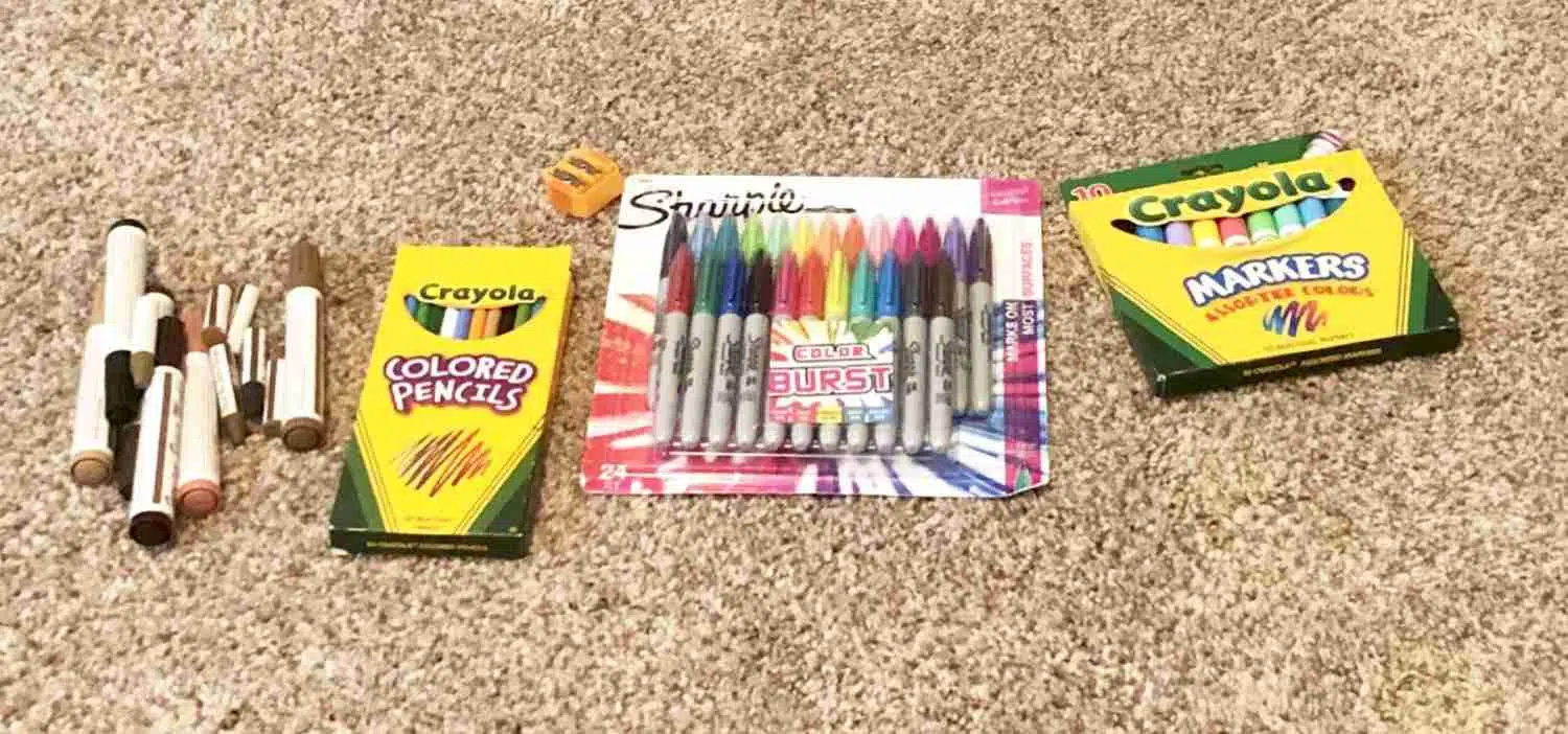markers sorted on a carpeted floor.