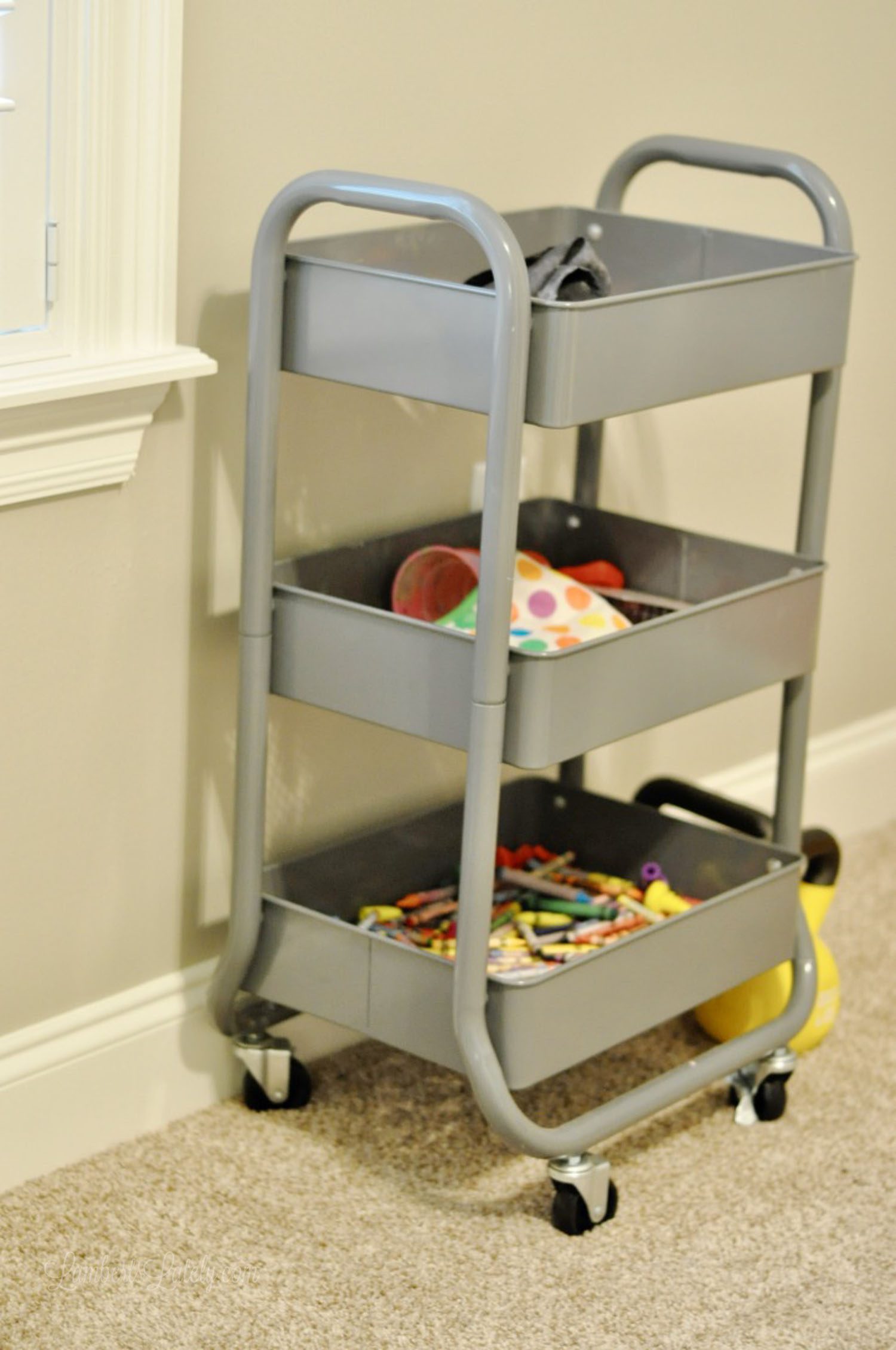 gray metal rolling organizer holding craft supplies.
