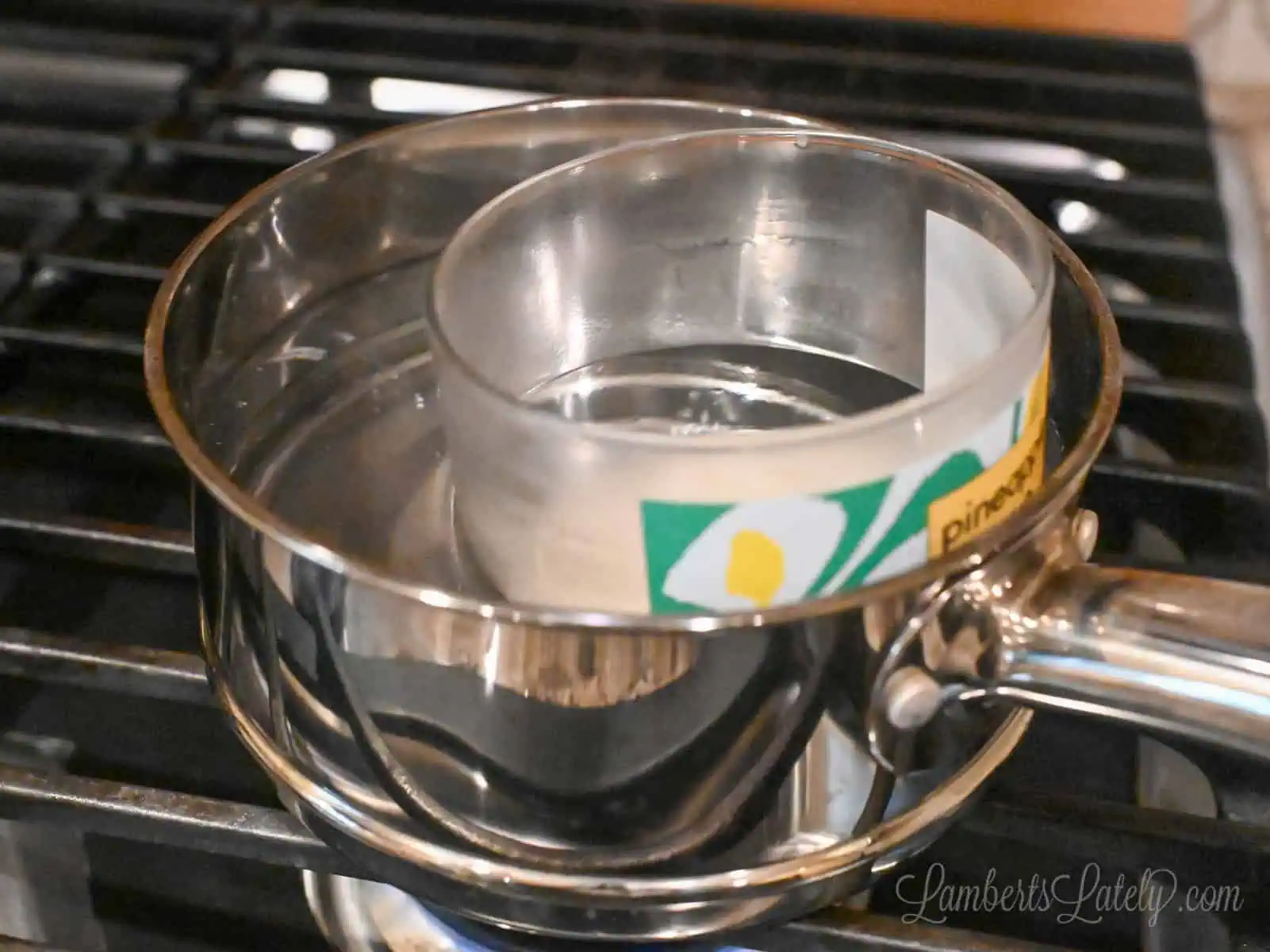 used candle in a saucepan on the stove.