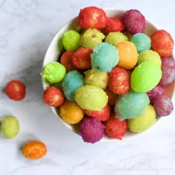 colorful frozen sour patch grapes in a ramekin.