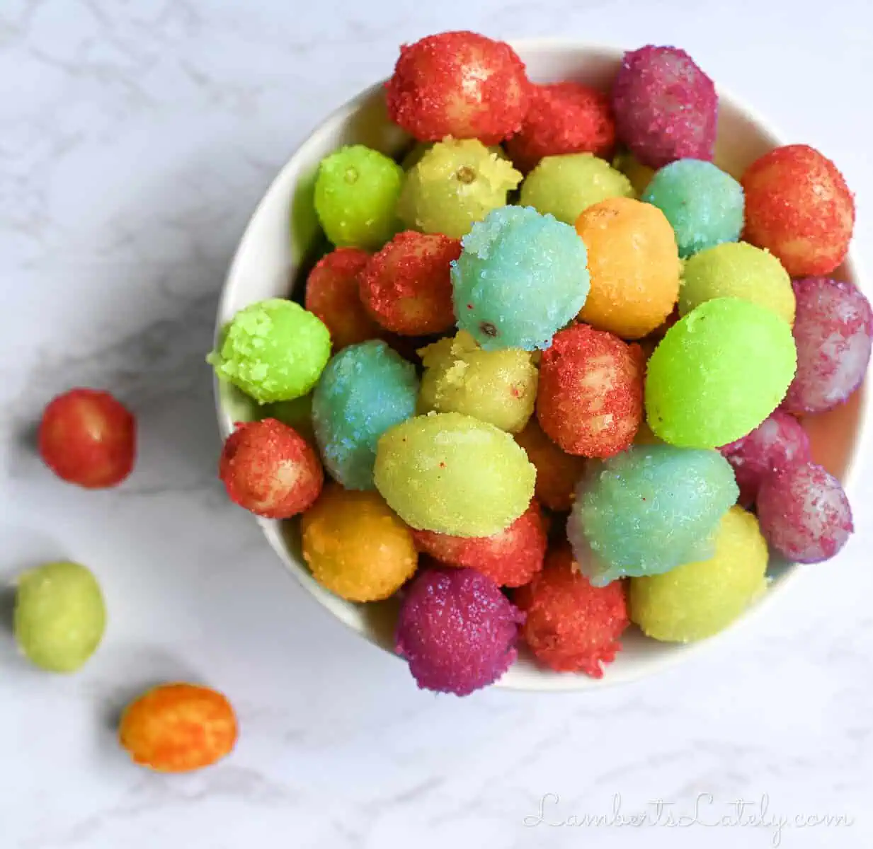 colorful frozen sour patch grapes in a ramekin.