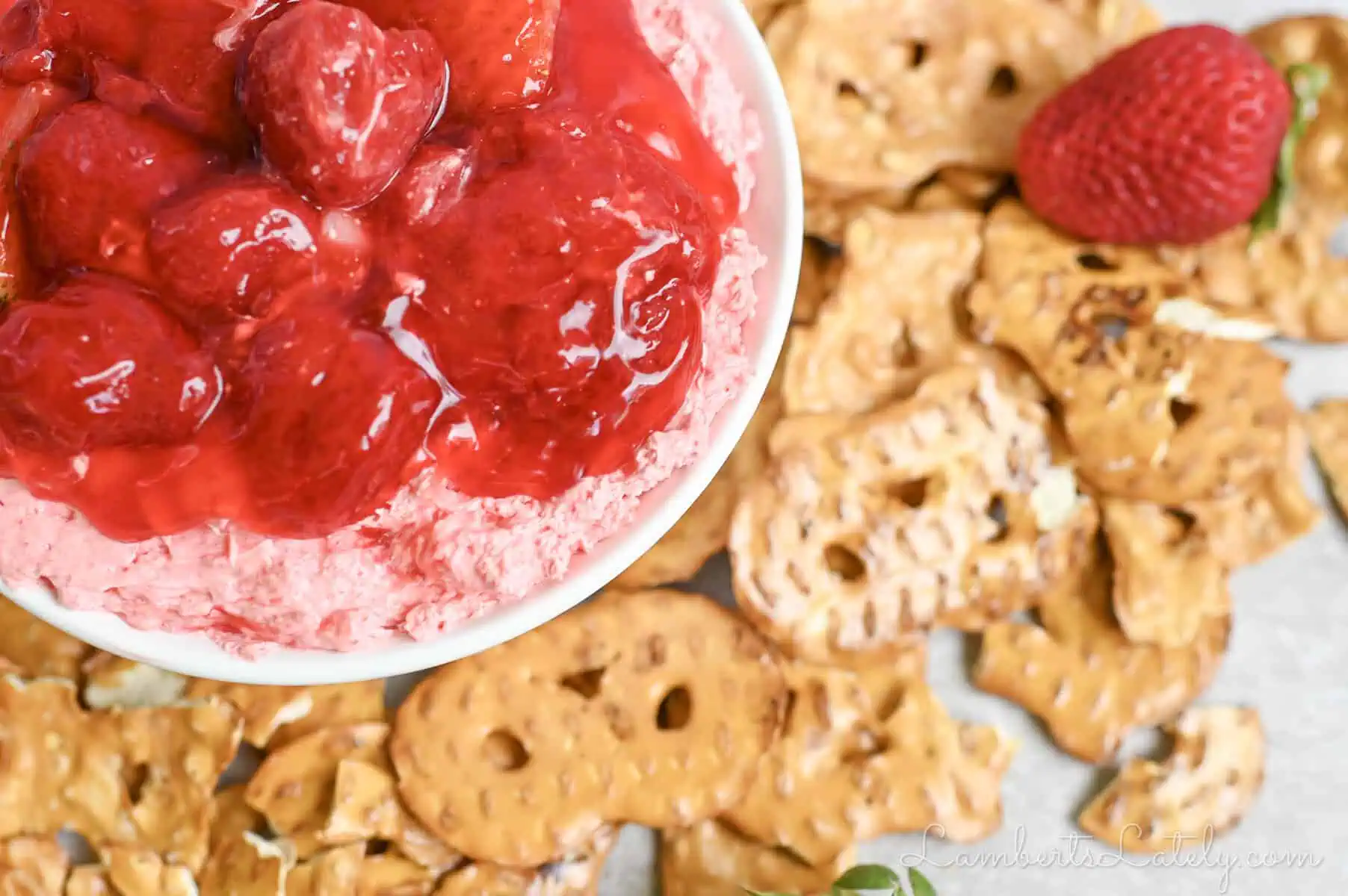 strawberry pretzel dip in a ramekin, covered in strawberry pie filling.