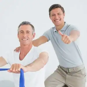 Men exercising with resistance bands, smiling, and showing thumbs up.