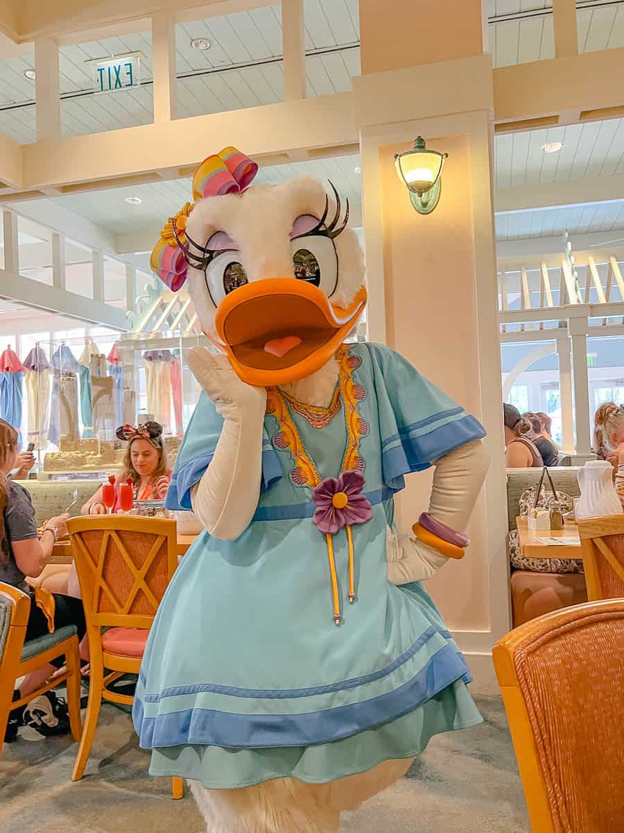 Daisy poses for a photo at Cape May Cafe in the Epcot Resorts Area