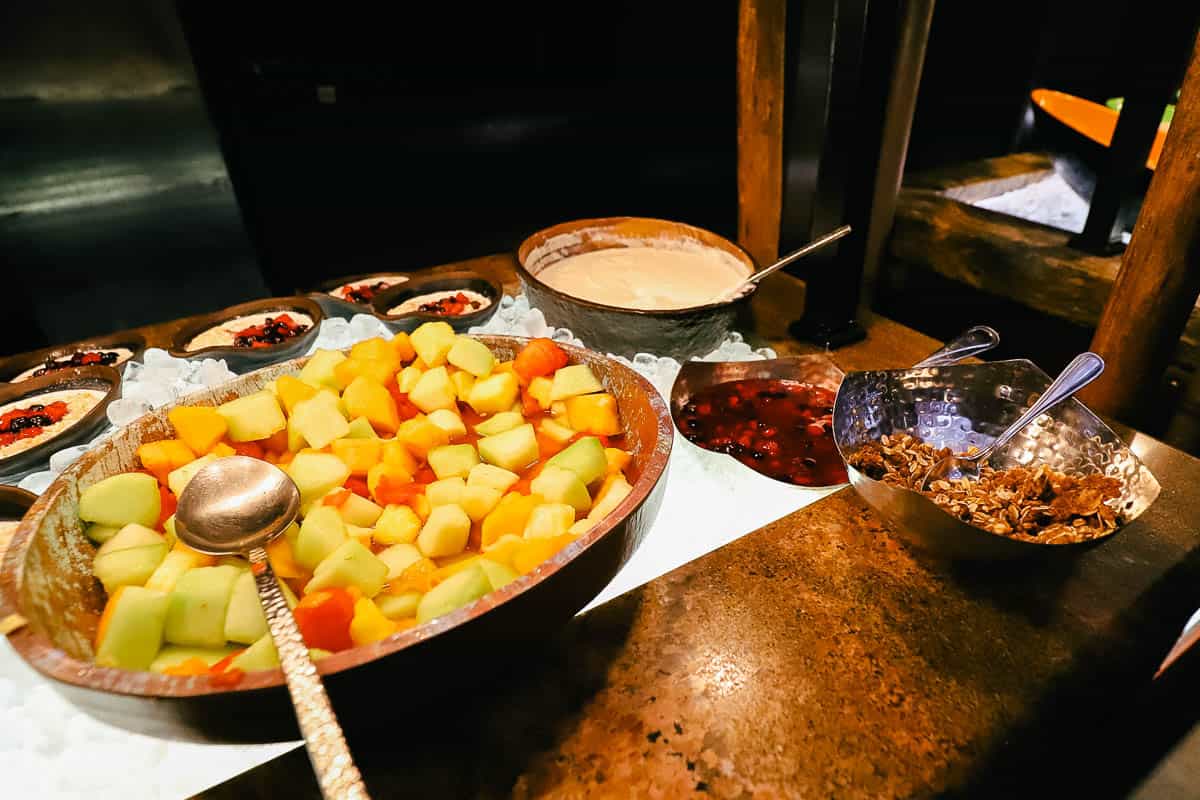 a bowl with cut fruit 