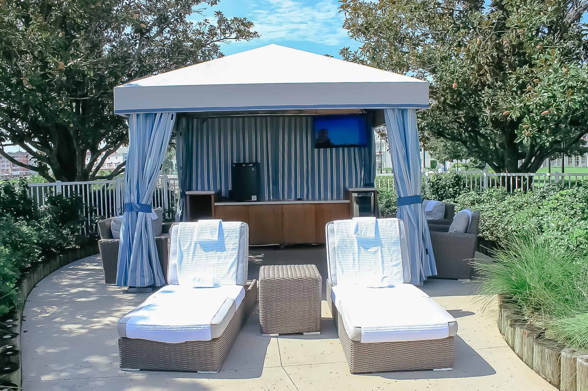 A cabana at Stormalong Bay with two lounge chairs toward the front.